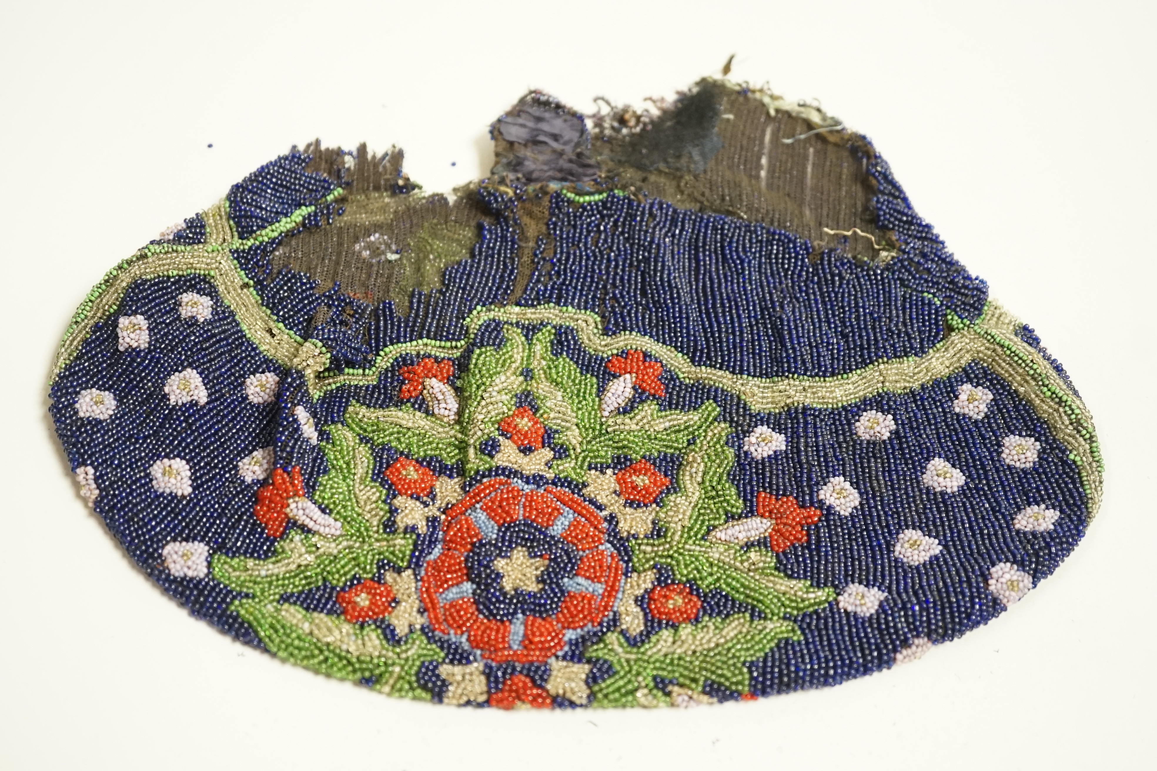 A velvet and metal embroidered reticule possibly 18th century, together with a collection of beaded embroidered knitted and leather purses, bags misers purses and a feather coin purse(14)